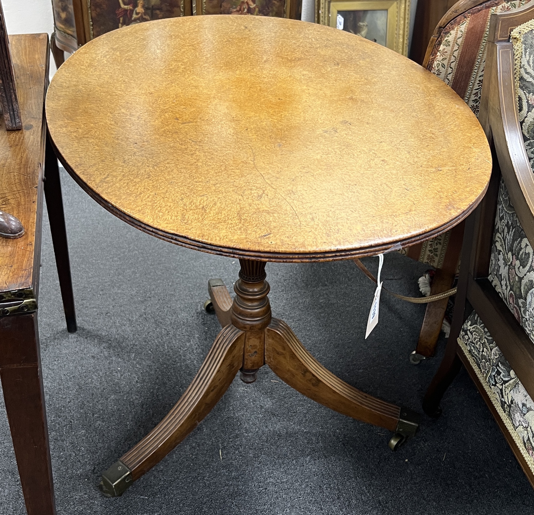 A George III bird's eye maple oval tilt top tea table, width 90cm, depth 68cm, height 71cm